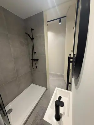 a bathroom with a shower and a white bath tub at Luxury Apartment Antwerp Port Moerbeke 2 in Lokeren