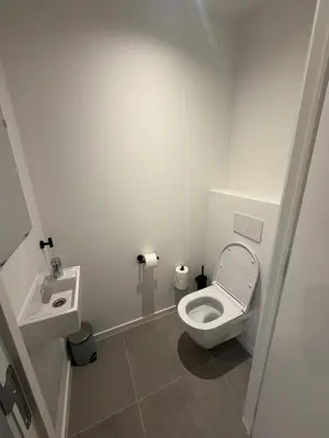 a white bathroom with a toilet and a sink at Luxury Apartment Antwerp Port Moerbeke 2 in Lokeren