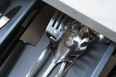 a pair of utensils sitting on top of a counter at Lovely 1BR & 1LR Apartment, Only 15 Min Walk to City Center in Ghent