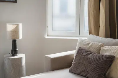a living room with a couch and a window at Lovely 1BR & 1LR Apartment, Only 15 Min Walk to City Center in Ghent
