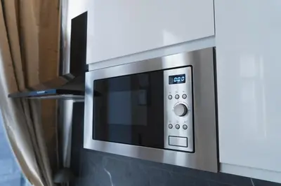a stainless steel microwave oven in a kitchen at Lovely 1BR & 1LR Apartment, Only 15 Min Walk to City Center in Ghent
