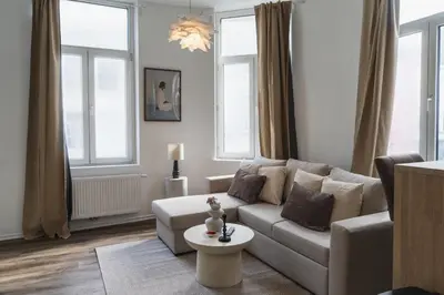a living room with a couch and a table at Lovely 1BR & 1LR Apartment, Only 15 Min Walk to City Center in Ghent