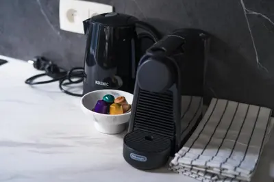 a black coffee maker sitting next to a bowl ofools at Lovely 1BR & 1LR Apt for 4P, Only 15 Min Walk to City Center in Ghent