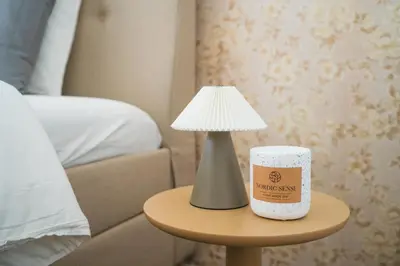 a lamp and a cup on a table next to a bed at Lovely 1BR & 1LR Apt for 4P, Only 15 Min Walk to City Center in Ghent