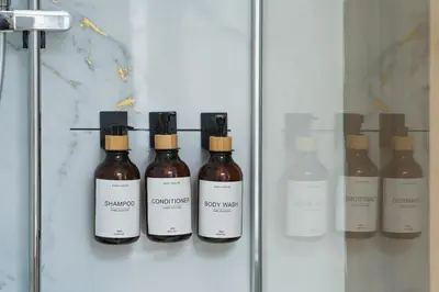 a display case with five bottles of liquid at Lovely 1BR & 1LR Apt for 4P, Only 15 Min Walk to City Center in Ghent