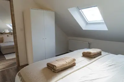 a bedroom with a bed with two towels on it at Cozy 1BR & Living Room Apartment, Just 15 Minutes to Downtown in Ghent