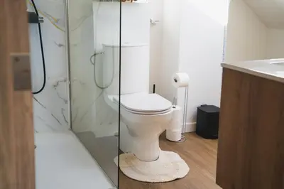 a bathroom with a toilet and a glass shower at Cozy 1BR & Living Room Apartment, Just 15 Minutes to Downtown in Ghent