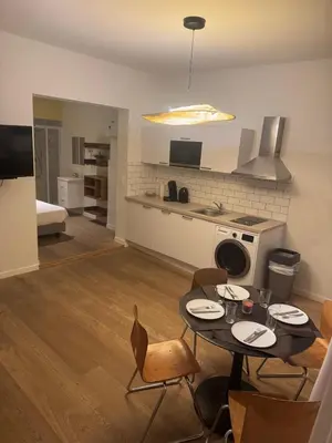 a kitchen and living room with a table and chairs at Studio 003 Avenue Louise in Brussels