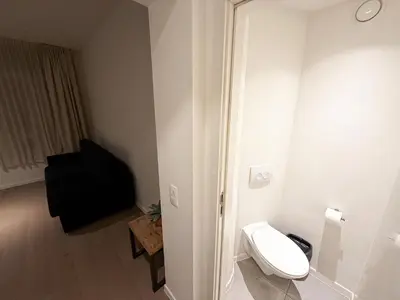a small bathroom with a toilet and a chair at Studio 003 Avenue Louise in Brussels