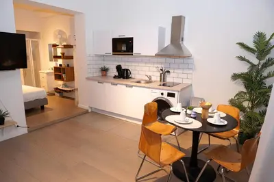 a kitchen and living room with a table and chairs at Studio 003 Avenue Louise in Brussels
