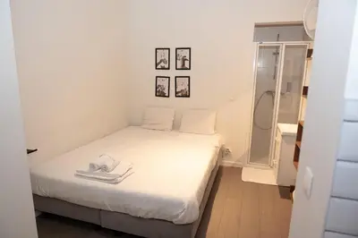 a small bedroom with a bed and a shower at Studio 003 Avenue Louise in Brussels