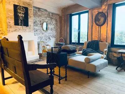 a living room with a couch and a chair at Legions Suite in Antwerp
