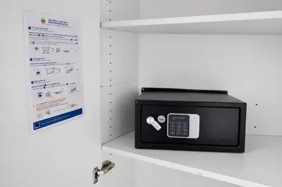 a microwave oven sitting on a shelf next to a wall at cozy studio Brussels airport in Steenokkerzeel