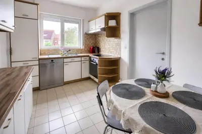 a kitchen with a table and chairs in a room at cozy studio Brussels airport in Steenokkerzeel