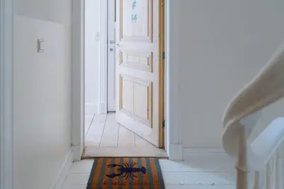 an open door with a spider on a rug in a hallway at Urban Hideout Just Steps from Antwerp's Highlights in Antwerp