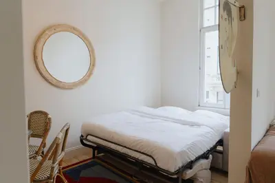 a bedroom with a bed and a mirror on the wall at Urban Hideout Just Steps from Antwerp's Highlights in Antwerp