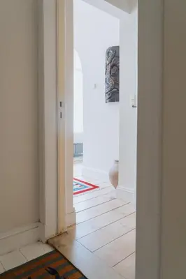an empty room with a hallway with white walls at Urban Hideout Just Steps from Antwerp's Highlights in Antwerp