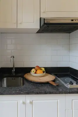 a bowl of fruit on a cutting board on a kitchen counter at Urban Hideout Just Steps from Antwerp's Highlights in Antwerp