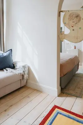 a living room with a couch and a rug at Urban Hideout Just Steps from Antwerp's Highlights in Antwerp