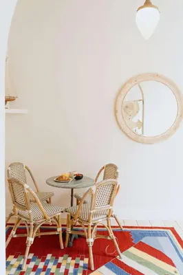 a dining room with a table and chairs and a mirror at Urban Hideout Just Steps from Antwerp's Highlights in Antwerp