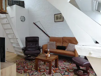 a living room with a couch and a chair at 3 units - Logies De Lelie in Antwerp