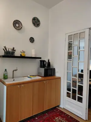 a kitchen with a sink and a microwave on the wall at 3 units - Logies De Lelie in Antwerp