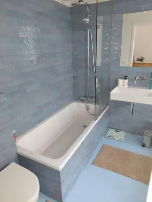 a bathroom with a tub and a toilet and a sink at 3 units - Logies De Lelie in Antwerp