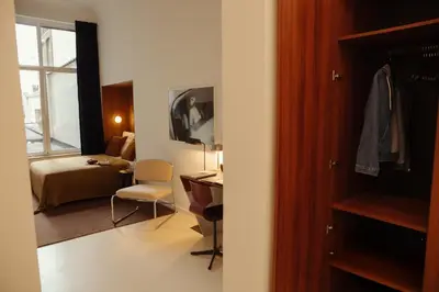 a room with a bedroom with a bed and a desk at A Place - Boutique Hotel - Meir 24 in Antwerp