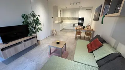 a living room with a couch and a table at Casa Kim in Willebroek