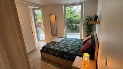 a small bedroom with a bed and a window at Casa Kim in Willebroek