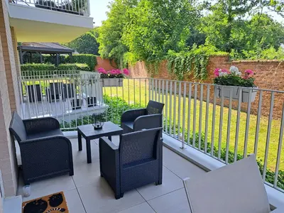 a patio with chairs and a table and a fence at Casa Kim in Willebroek