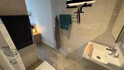 a bathroom with a sink and a shower at Casa Kim in Willebroek