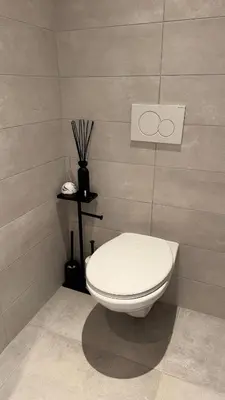 a bathroom with a white toilet in a room at Casa Kim in Willebroek
