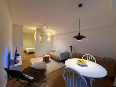 a living room with a white table and chairs at European Smart Studio in Brussels