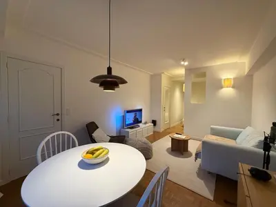 a living room with a white table and a couch at European Smart Studio in Brussels