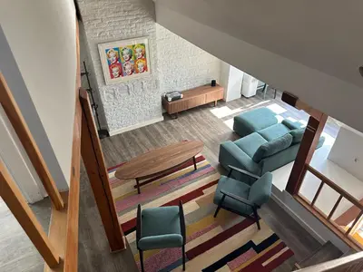an overhead view of a living room with a couch and chairs at Charming Entire Apartment in Saint-Gilles, Brussels in Brussels