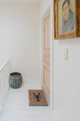 a painting of a man next to a door at Cozy Apartment in Central Antwerp in Antwerp