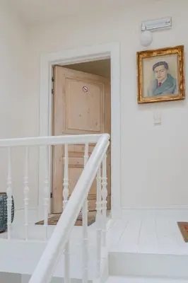a stairway with a picture of a man on the wall at Cozy Apartment in Central Antwerp in Antwerp