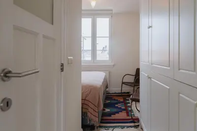 a bedroom with a bed and a window and a door at Cozy Apartment in Central Antwerp in Antwerp