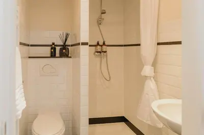 a bathroom with a shower with a toilet and a sink at Cozy Apartment in Central Antwerp in Antwerp