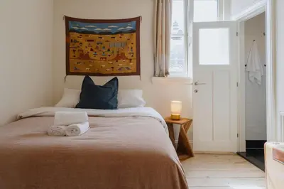 a bedroom with a bed with towels on it at Cozy Hideaway Near the Heart of Antwerp in Antwerp