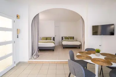 a room with two beds and a table and chairs at Schuman 2 in Brussels