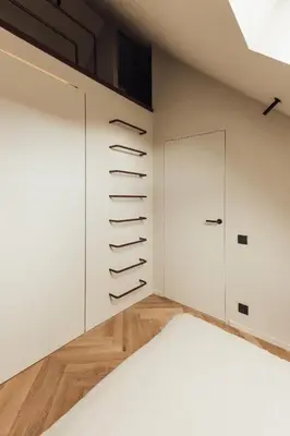 a bedroom with white walls and a door at LEO - Antwerp in Antwerp