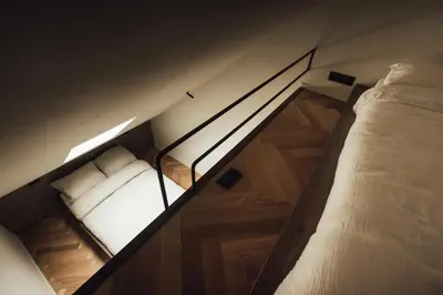 two bunk beds in a room with wooden floors at LEO - Antwerp in Antwerp