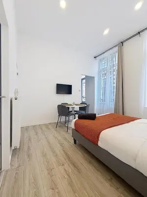 a bedroom with a bed and a desk with a computer at Fernand Cocq in Brussels