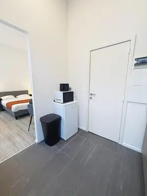 a room with a door and a bedroom with a bed at Fernand Cocq in Brussels