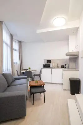 a living room with a couch and a table at Mérode 3 in Brussels