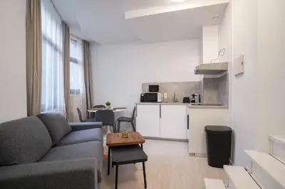 a living room with a couch and a table at Mérode 3 in Brussels