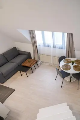 a living room with a couch and a table at Luxembourg 6 in Brussels