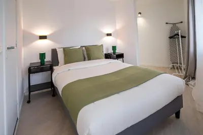 a bedroom with a large bed with two night stands at Luxembourg 6 in Brussels